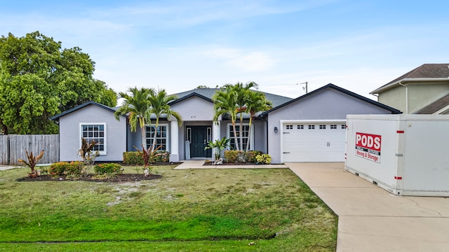 ranch-style home featuring a front yard and a garage