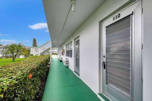 view of patio with a wall unit AC