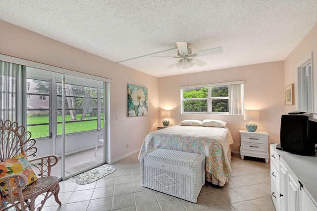 tiled bedroom with a textured ceiling, access to exterior, and ceiling fan