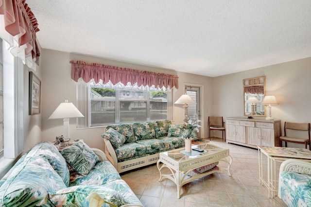 tiled living room featuring a textured ceiling