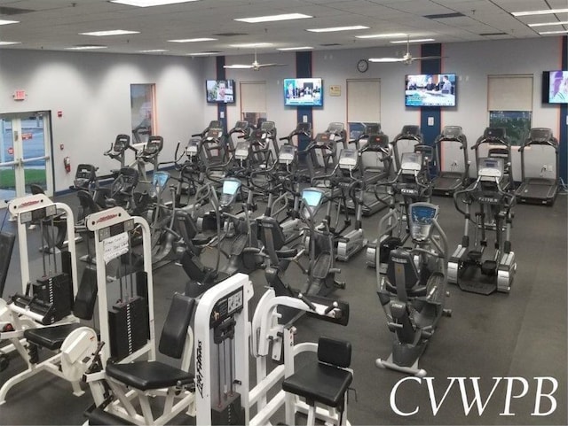 gym featuring a paneled ceiling and ceiling fan