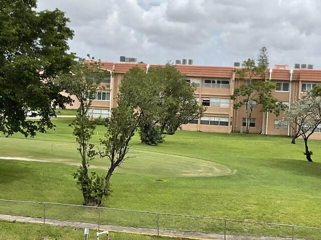 view of property's community with a lawn