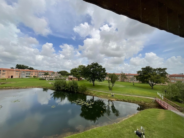 view of community featuring a water view and a yard