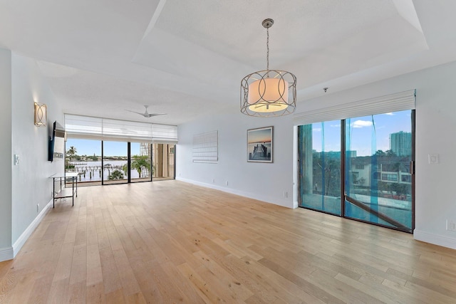 unfurnished living room with light wood-type flooring, ceiling fan, and a textured ceiling