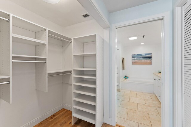 spacious closet featuring light tile patterned floors