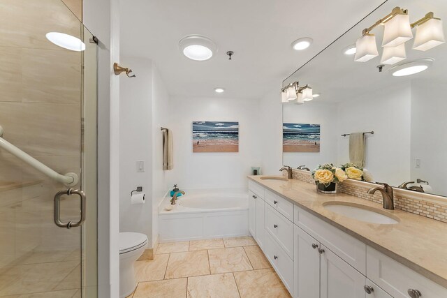 full bathroom featuring independent shower and bath, toilet, and vanity