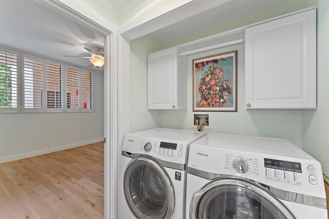 washroom with a textured ceiling, cabinets, washer and clothes dryer, light hardwood / wood-style floors, and ceiling fan