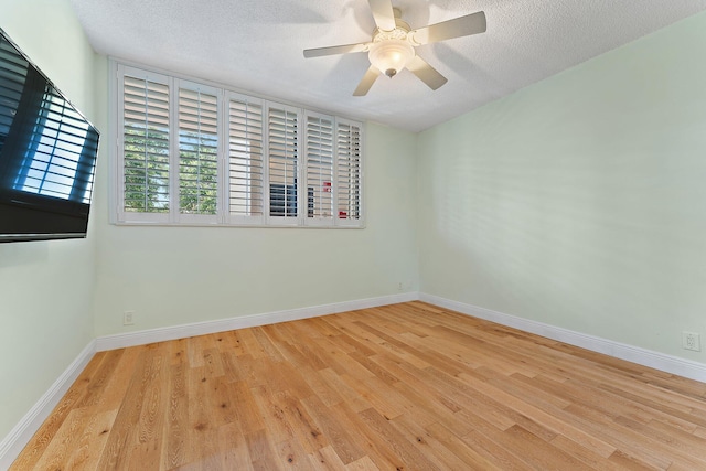 empty room with a textured ceiling, ceiling fan, and light wood-type flooring