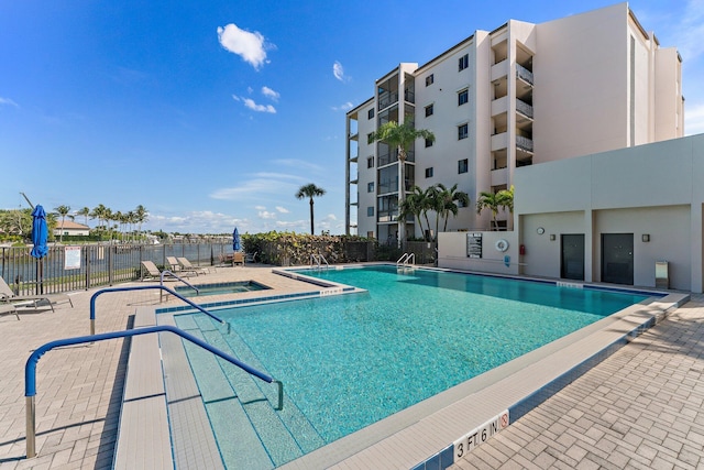 view of swimming pool featuring a community hot tub