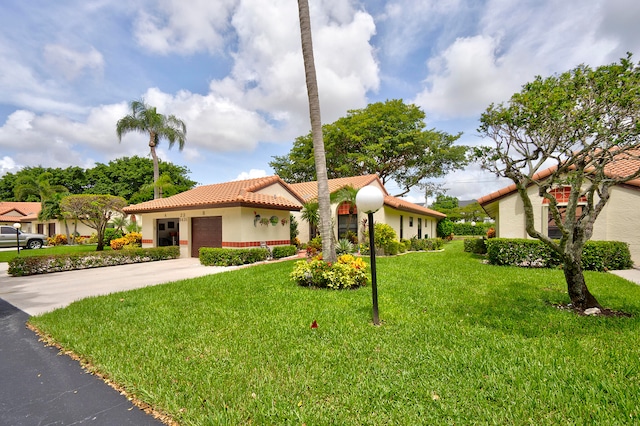 mediterranean / spanish-style house with a front yard