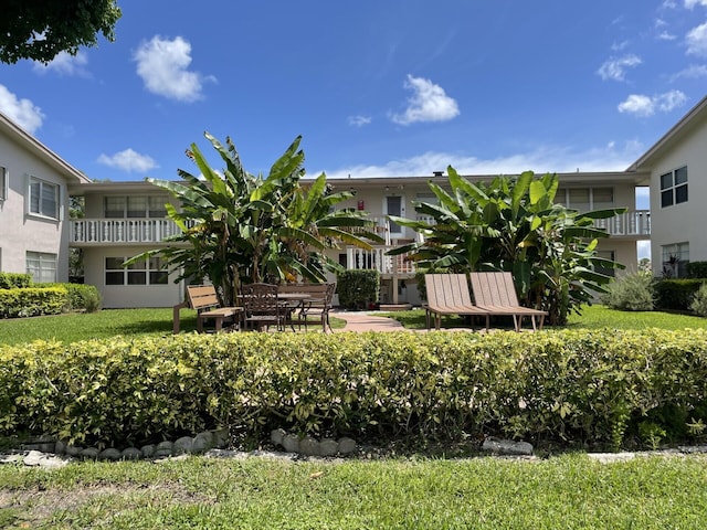 exterior space with a patio area, a balcony, and a front yard