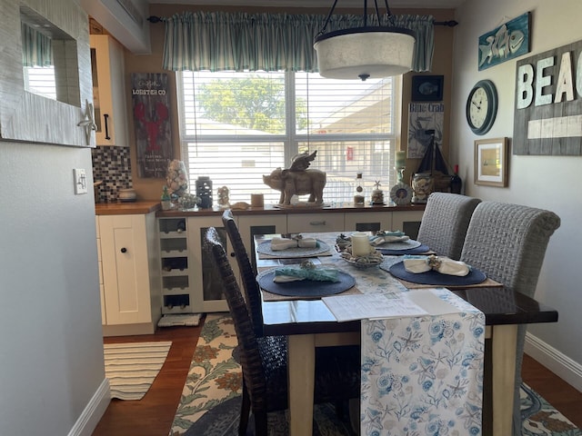 dining area with dark hardwood / wood-style flooring