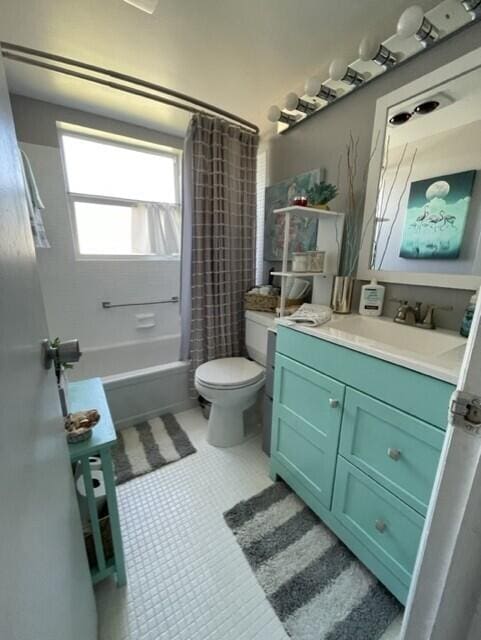 full bathroom featuring vanity, toilet, tile patterned floors, and shower / bath combo with shower curtain