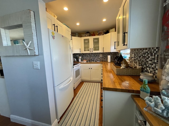 kitchen with white cabinetry, white appliances, tasteful backsplash, wood counters, and sink