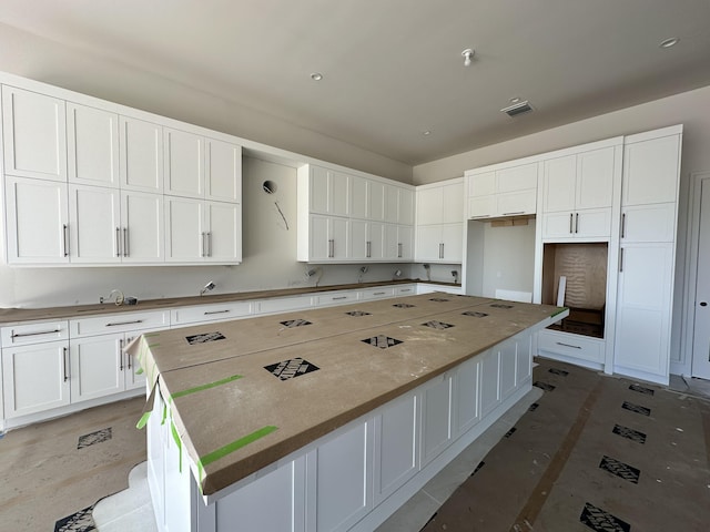 kitchen with a large island and white cabinetry