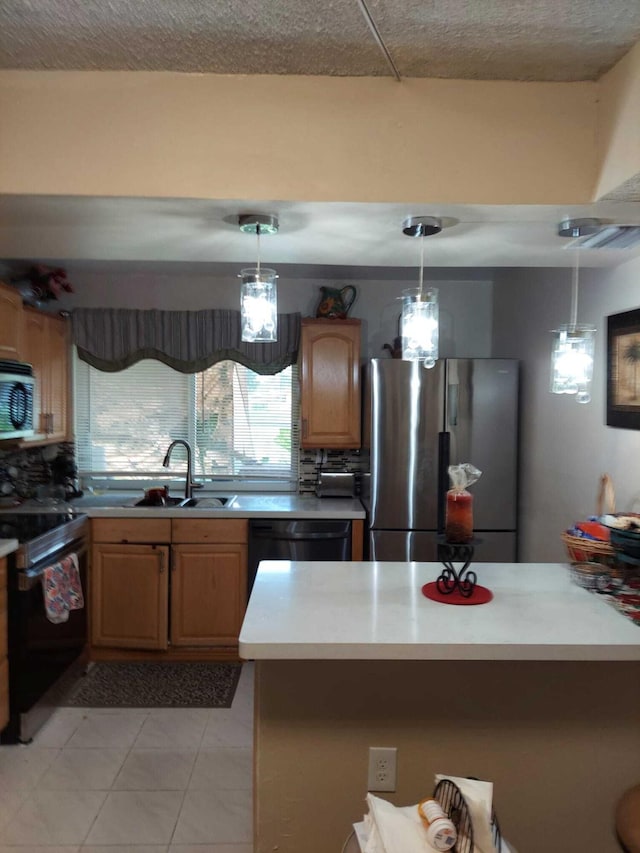 kitchen featuring light tile patterned floors, decorative light fixtures, stainless steel appliances, and sink