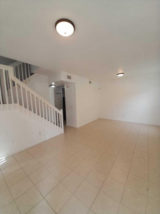 bonus room with light tile patterned flooring