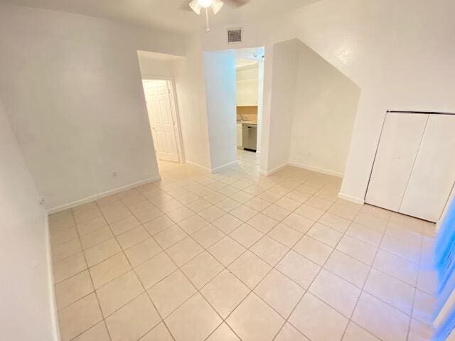 interior space with light tile patterned floors and ceiling fan