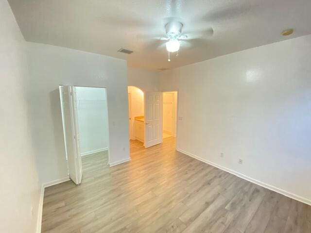 unfurnished bedroom with ceiling fan and hardwood / wood-style flooring