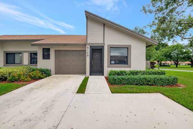 view of front of property with a garage and a front yard