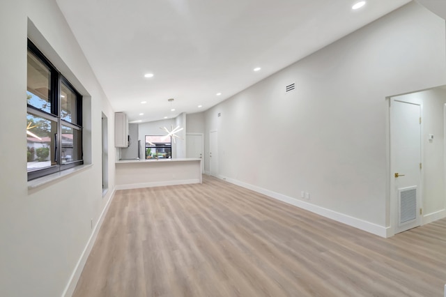 unfurnished living room with light hardwood / wood-style flooring and a healthy amount of sunlight