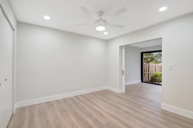 spare room featuring light hardwood / wood-style floors and ceiling fan