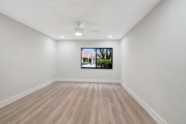 spare room with light hardwood / wood-style floors and ceiling fan