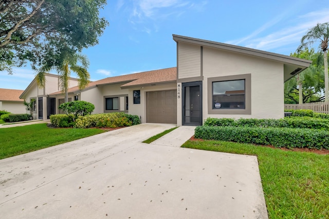 view of front of house featuring a front lawn and a garage