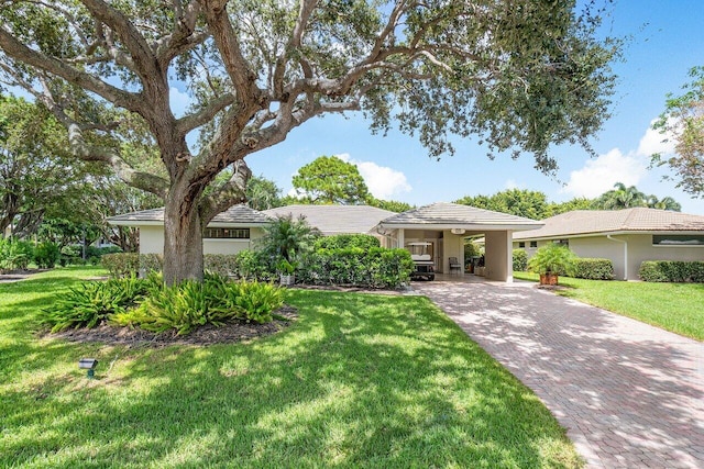 view of front facade with a carport and a front lawn