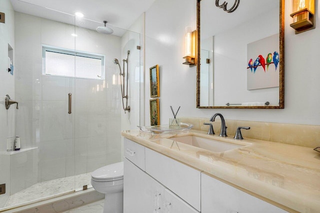 bathroom featuring an enclosed shower, toilet, and vanity