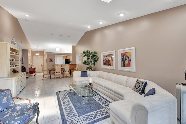 living room with lofted ceiling and light tile patterned floors