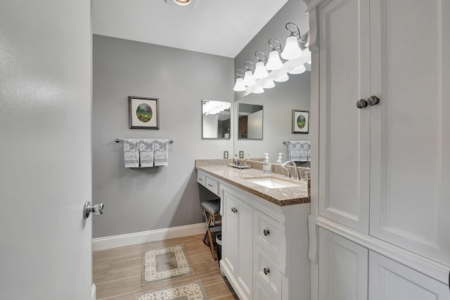 bathroom with hardwood / wood-style flooring and vanity