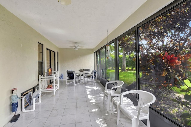 sunroom / solarium featuring ceiling fan