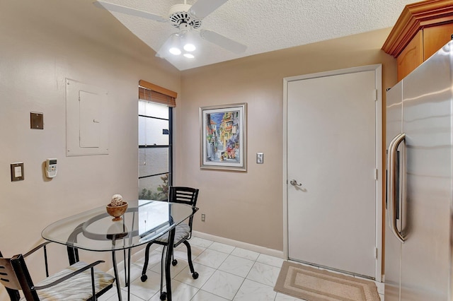 dining room with a textured ceiling, electric panel, ceiling fan, and lofted ceiling