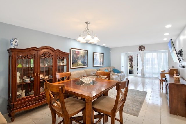 dining area with a notable chandelier and light tile patterned floors