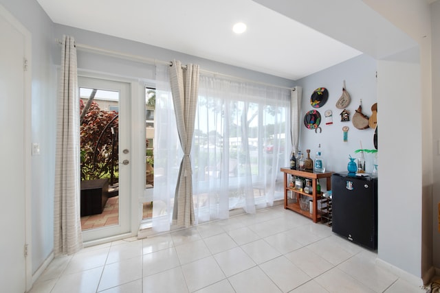 doorway to outside with light tile patterned floors