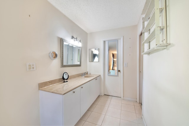 bathroom featuring tile patterned flooring, a textured ceiling, and vanity