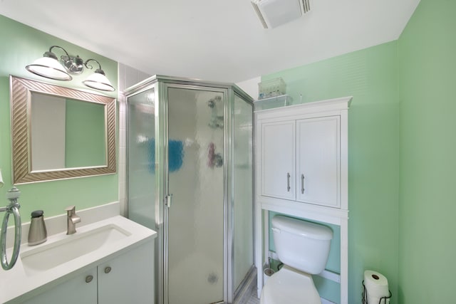 bathroom featuring vanity, toilet, and walk in shower