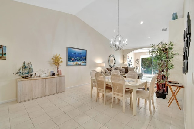 tiled dining area with high vaulted ceiling and a notable chandelier