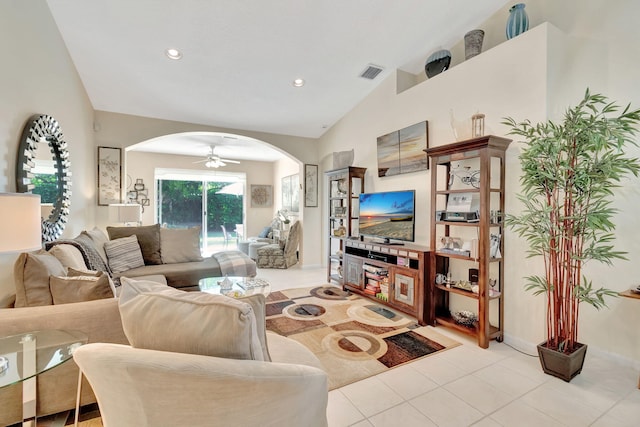 tiled living room with lofted ceiling and ceiling fan