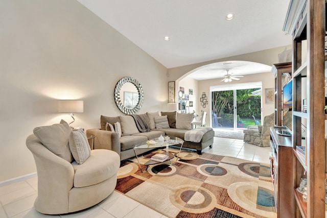 living room with lofted ceiling, ceiling fan, and light tile patterned floors