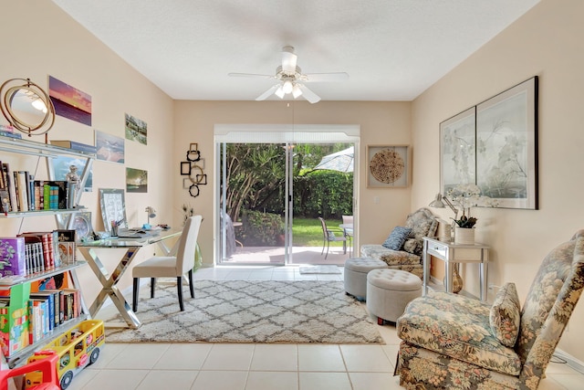 interior space with light tile patterned floors and ceiling fan