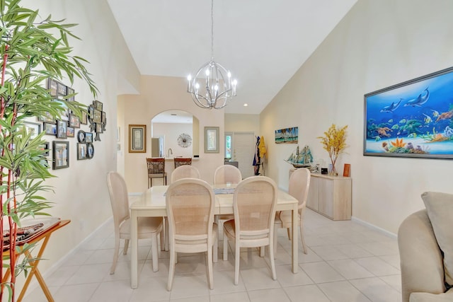 dining room with light tile patterned floors, high vaulted ceiling, and an inviting chandelier