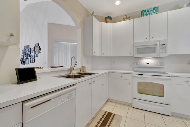 kitchen featuring white cabinets, white appliances, light tile patterned floors, and sink