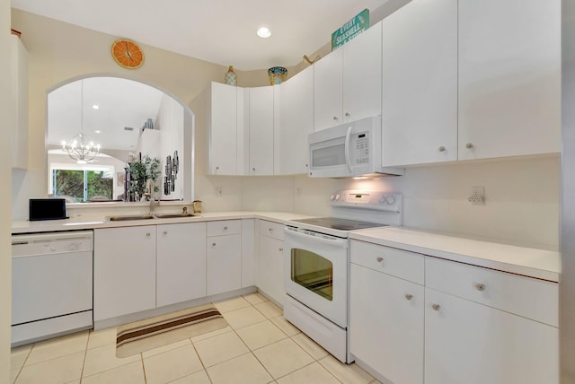 kitchen featuring white cabinetry, white appliances, and a notable chandelier