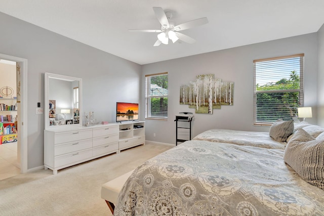 carpeted bedroom with ceiling fan and vaulted ceiling