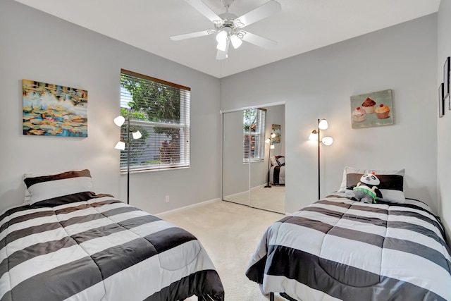 carpeted bedroom featuring ceiling fan and a closet