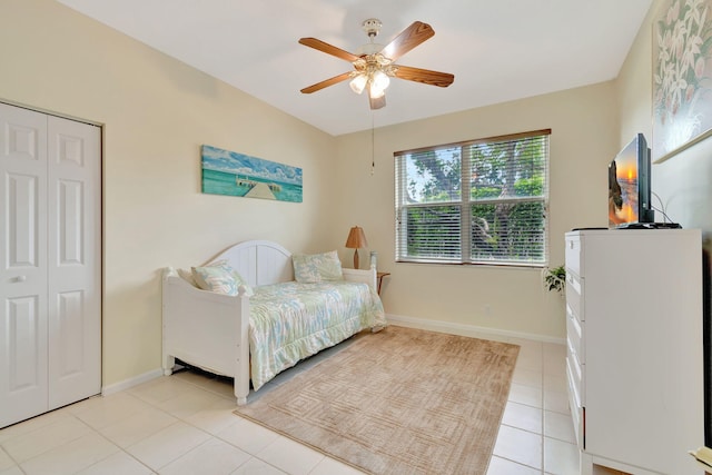 tiled bedroom with a closet and ceiling fan