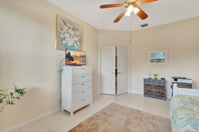 tiled bedroom with ceiling fan