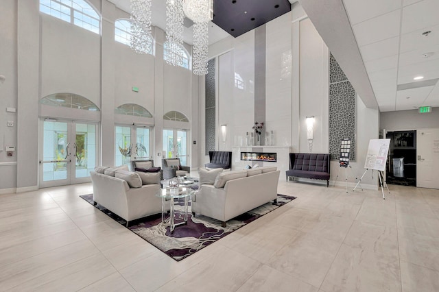 living room featuring a towering ceiling and french doors